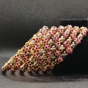 golden bangle with red stone