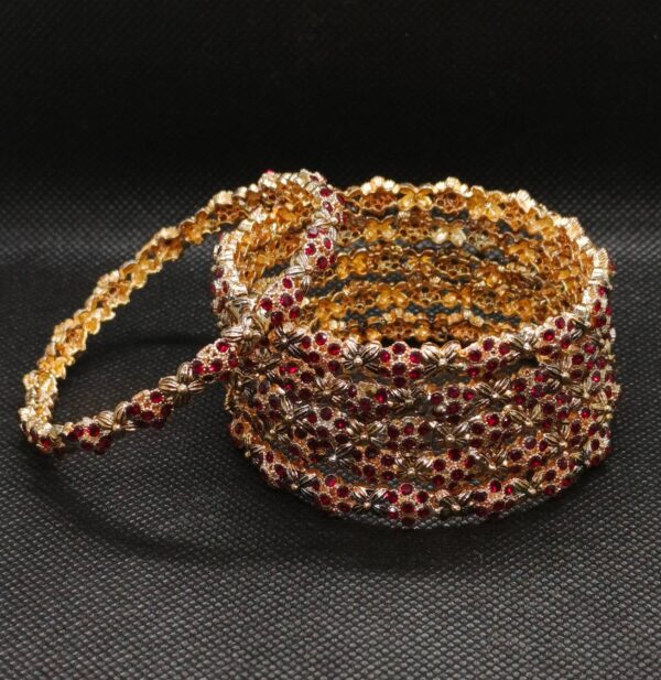 golden bangle with red stone